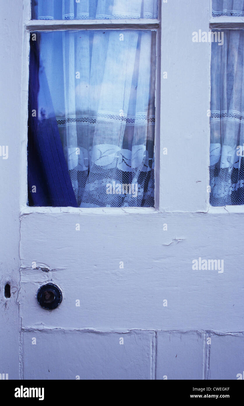 Detail Of Old Wooden White Painted Back Door With Glass Panels And