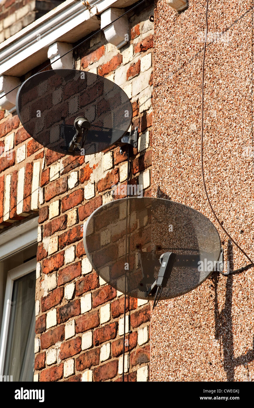 Satellite dishes mounted on residential property Stock Photo