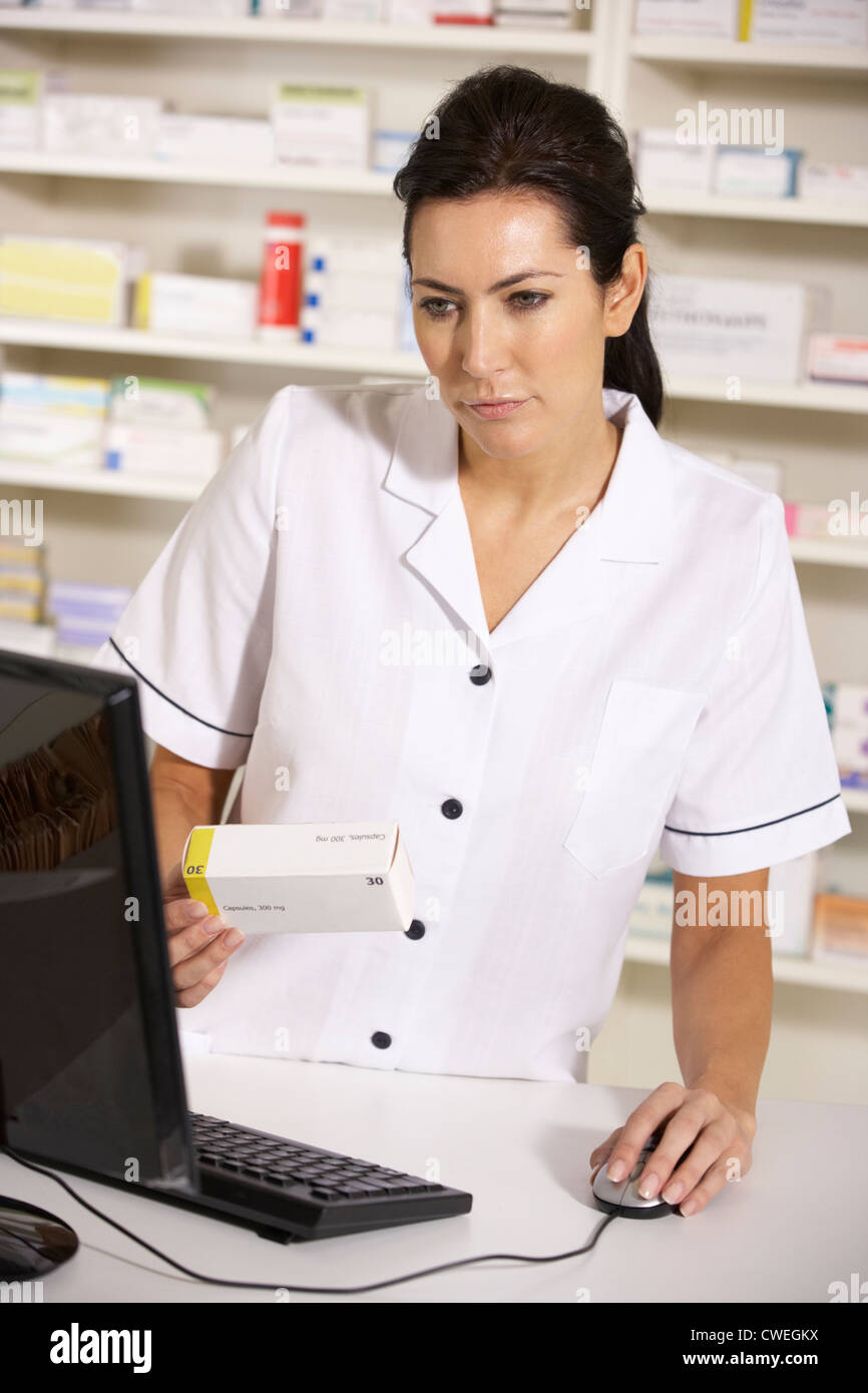 Pharmacist Using A Computer American pharmacist using computer in pharmacy Stock Photo - Alamy