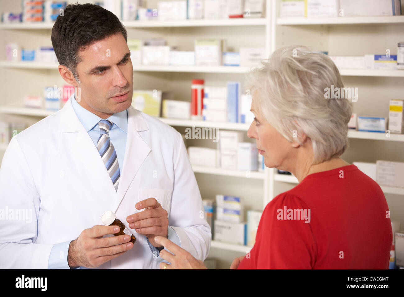 American pharmacist with senior woman in pharmacy Stock Photo