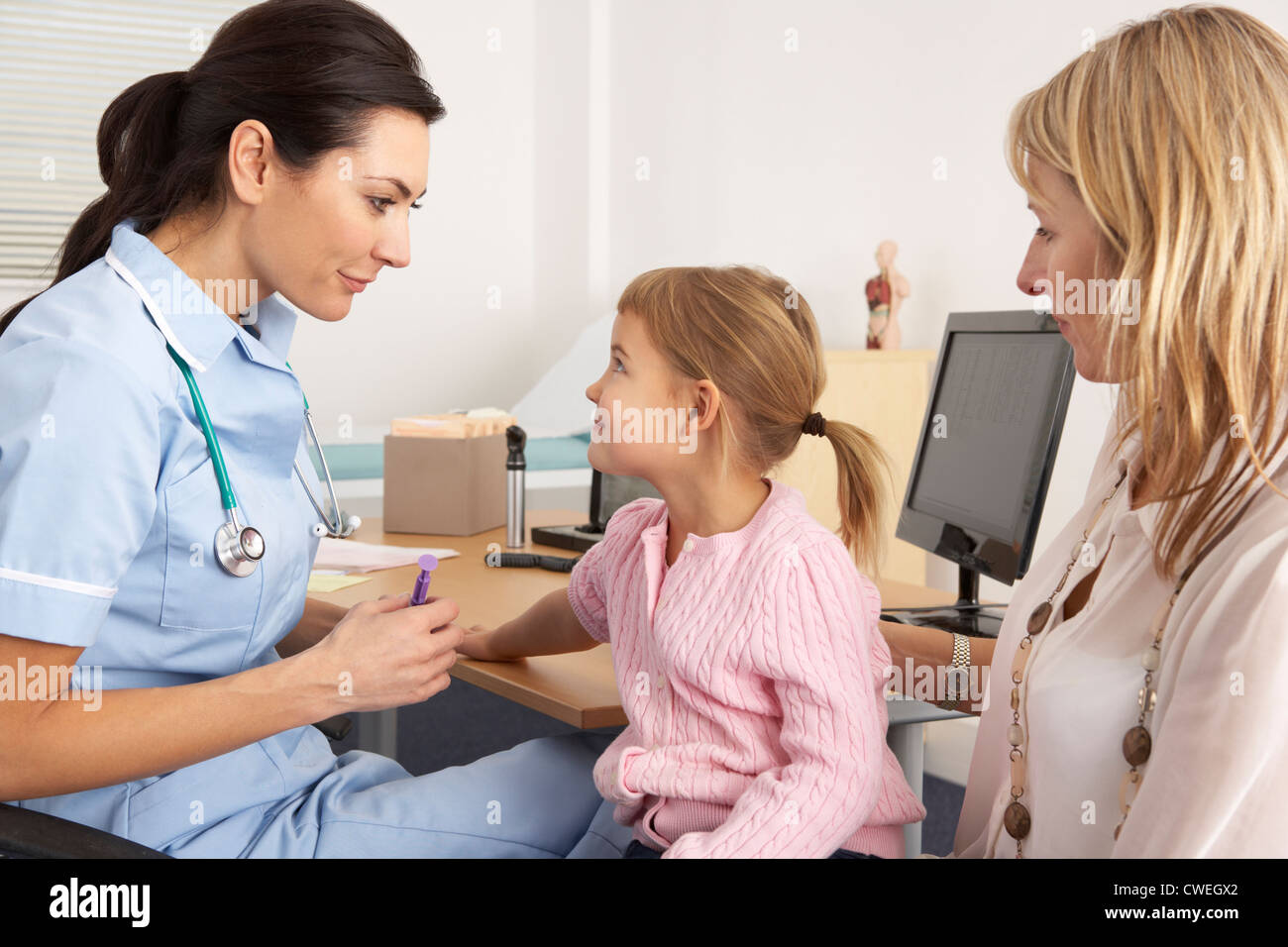 British nurse about to inject young child Stock Photo