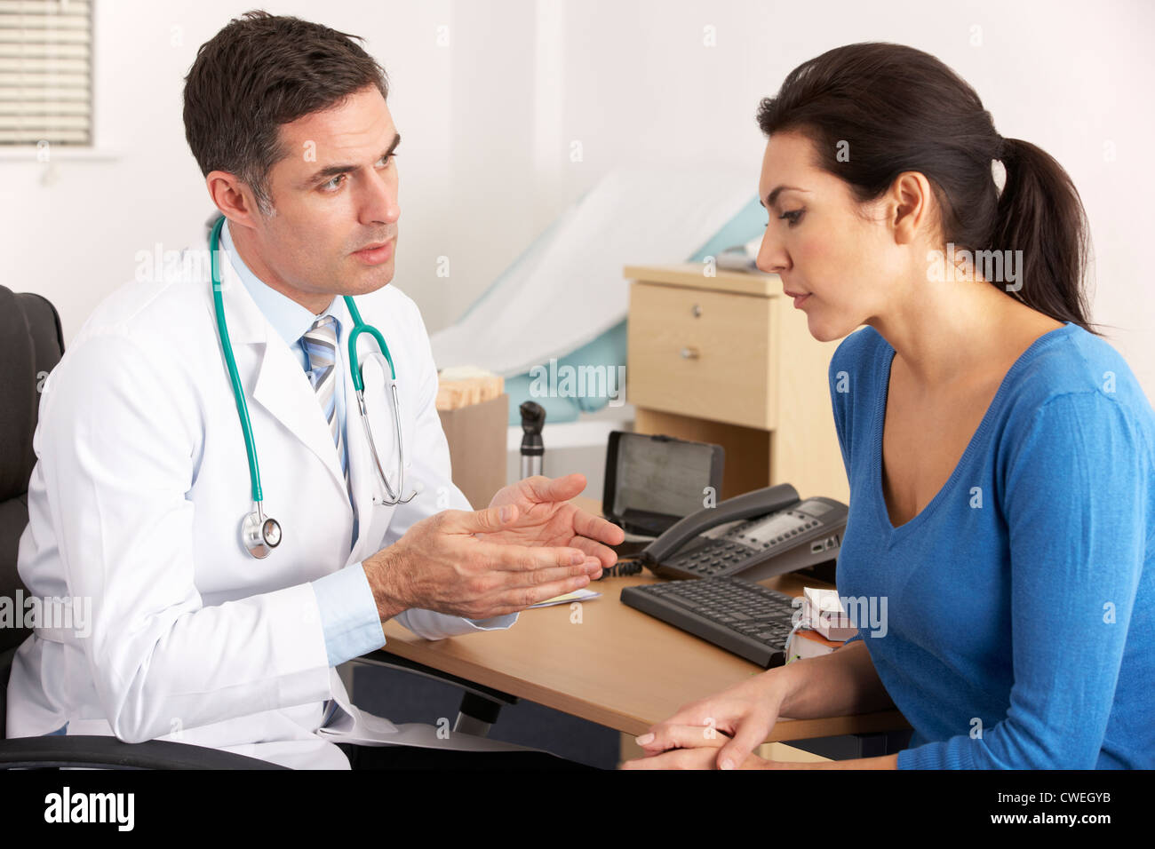 American doctor talking to woman in surgery Stock Photo