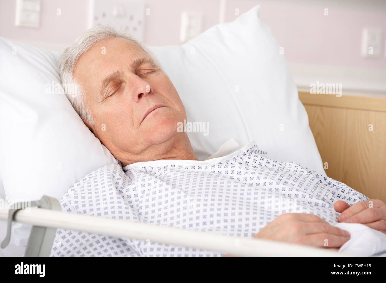 Senior man asleep in hospital bed Stock Photo Alamy