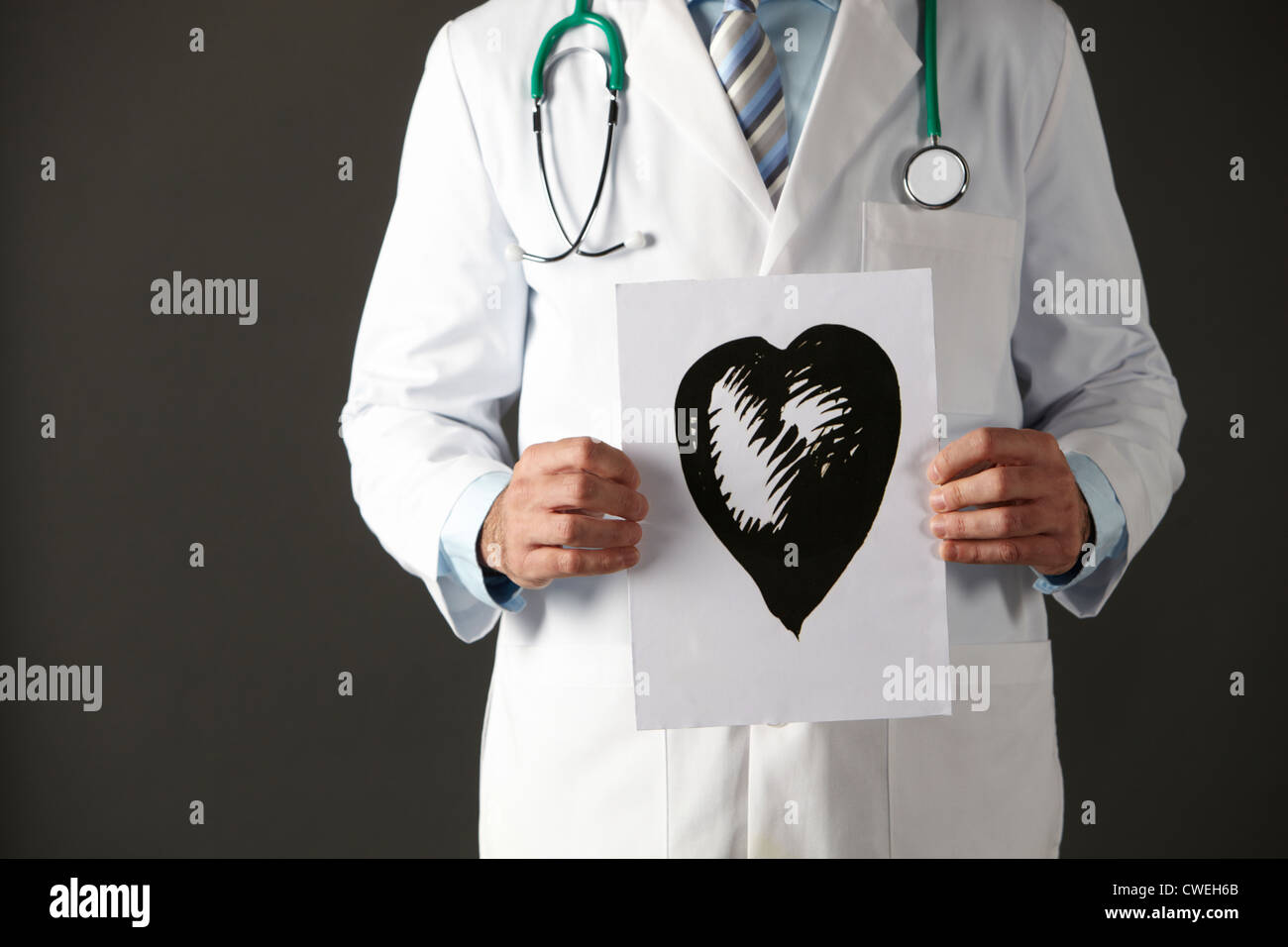 American doctor holding ink drawing of heart Stock Photo