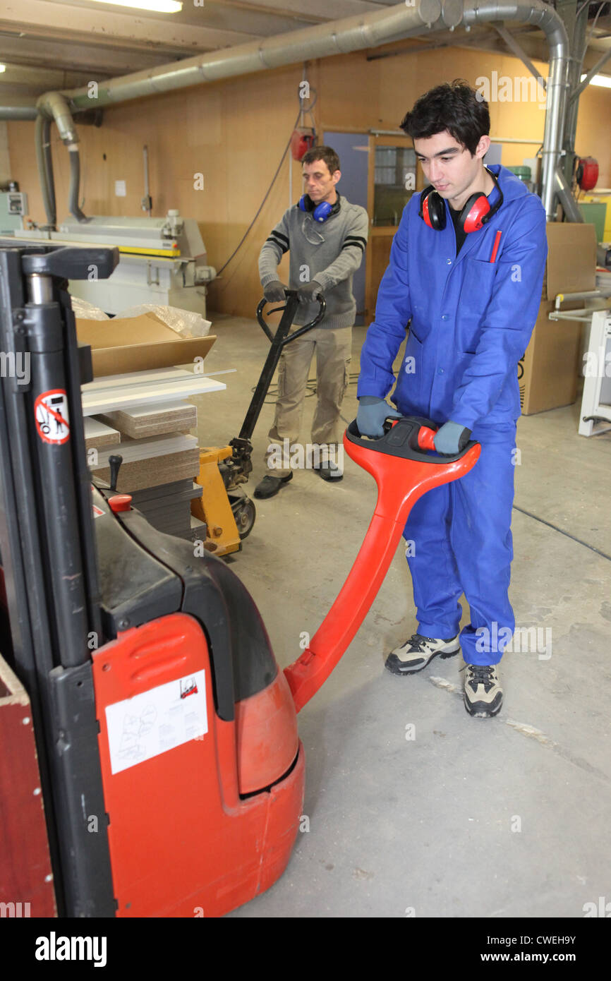 Two men moving pallets Stock Photo