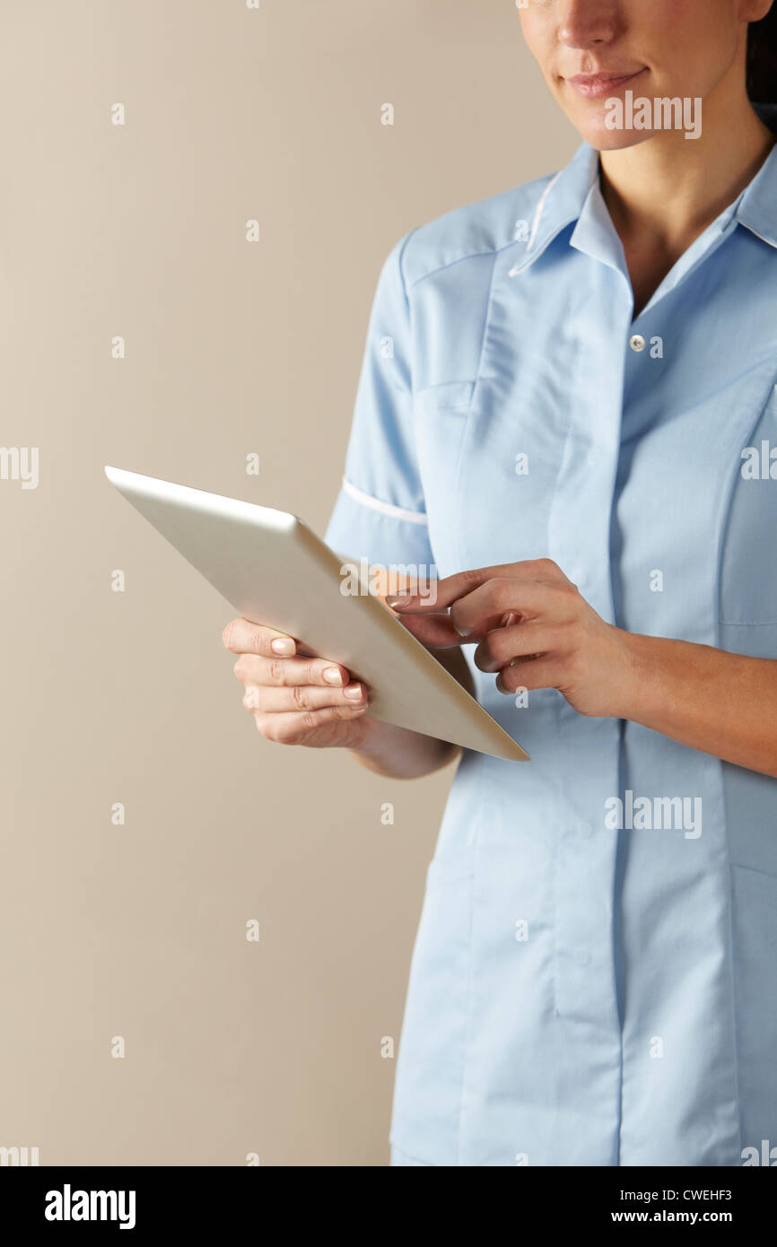 UK nurse using computer tablet Stock Photo