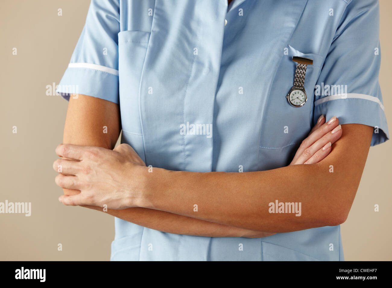 UK nurse standing with arms folded Stock Photo