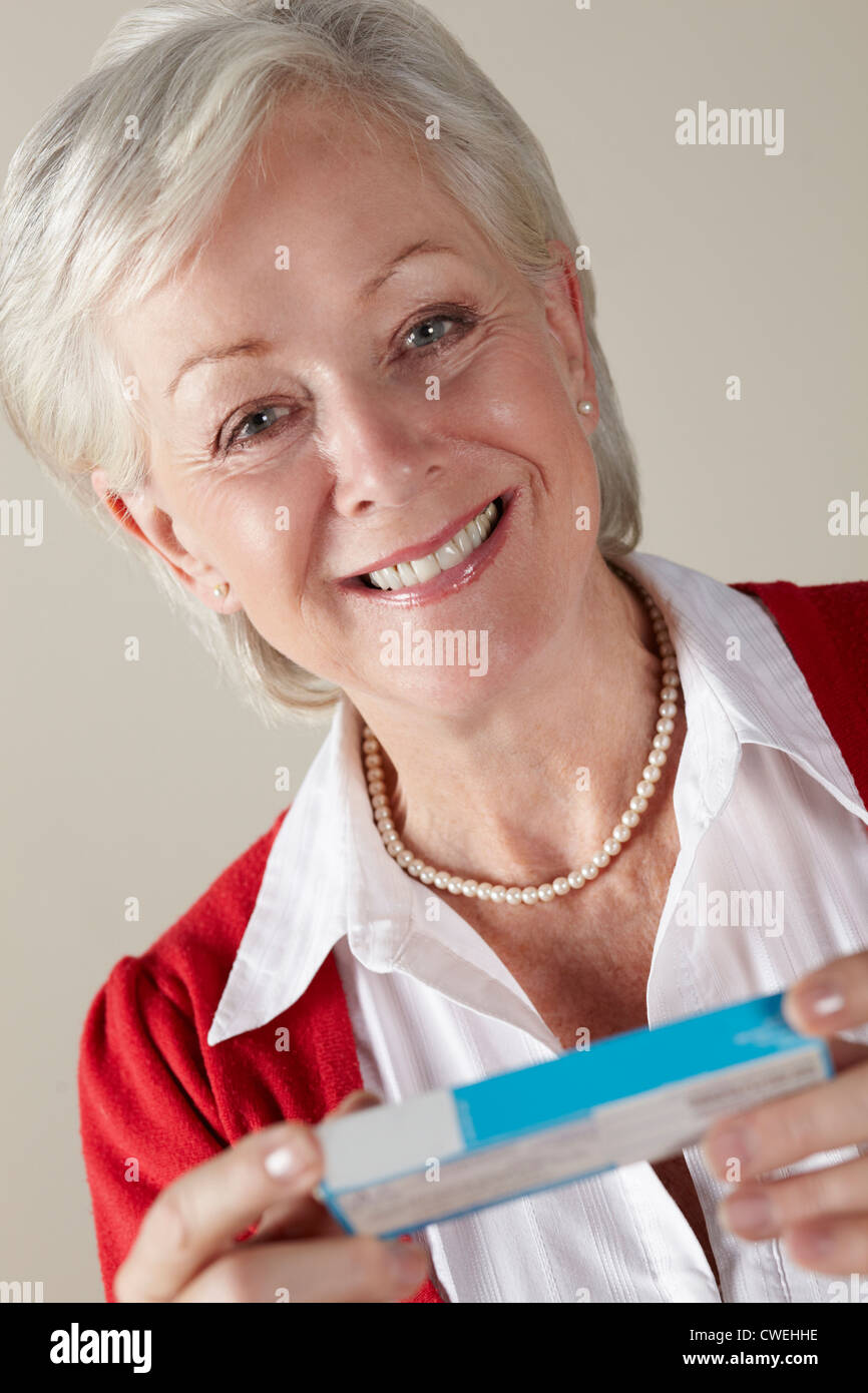 Senior woman holding prescription drug pack Stock Photo