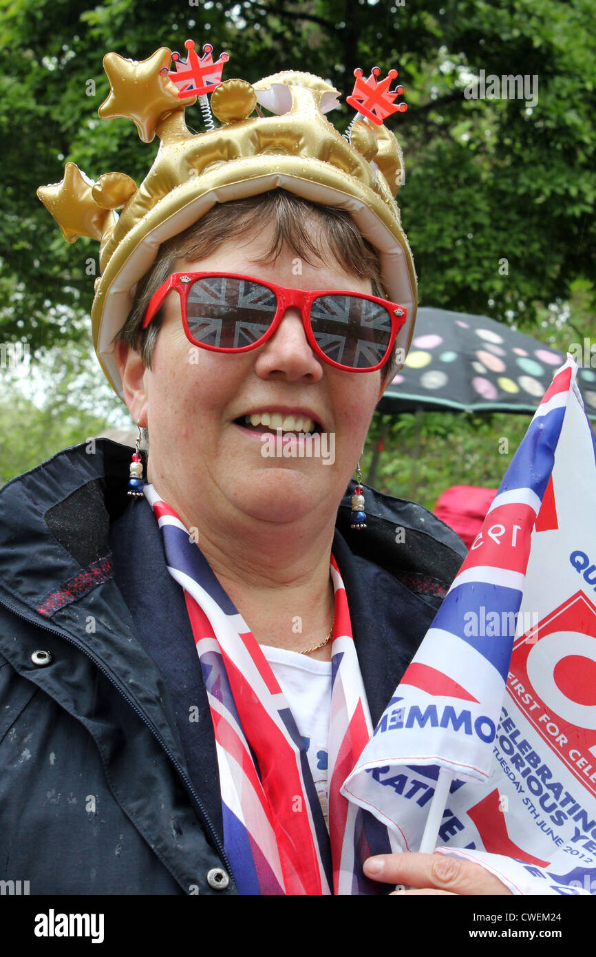 Portrait of a woman wearing union jack sunglasses and a crown