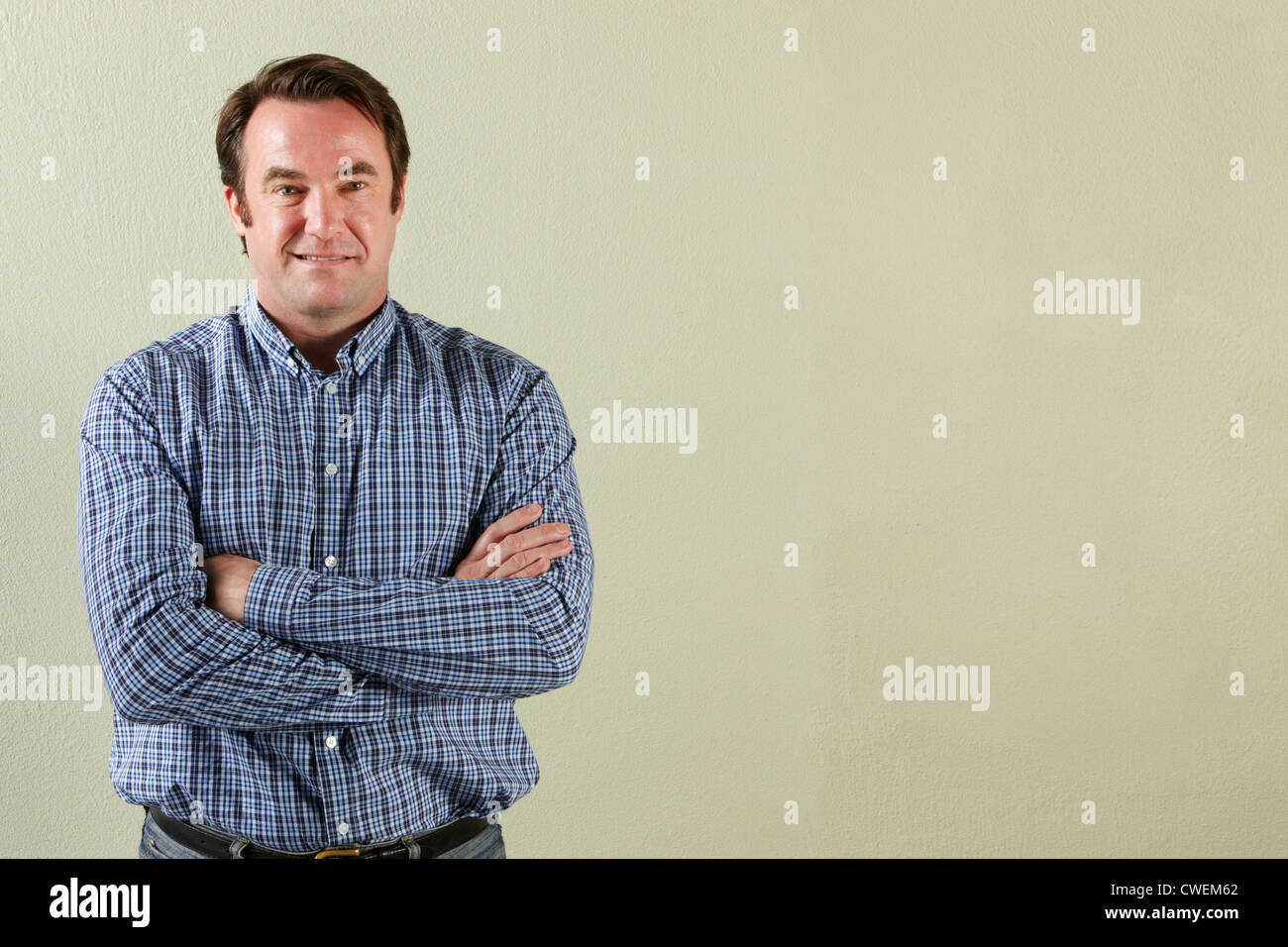 Studio Shot Of Relaxed Middle Aged Man Stock Photo