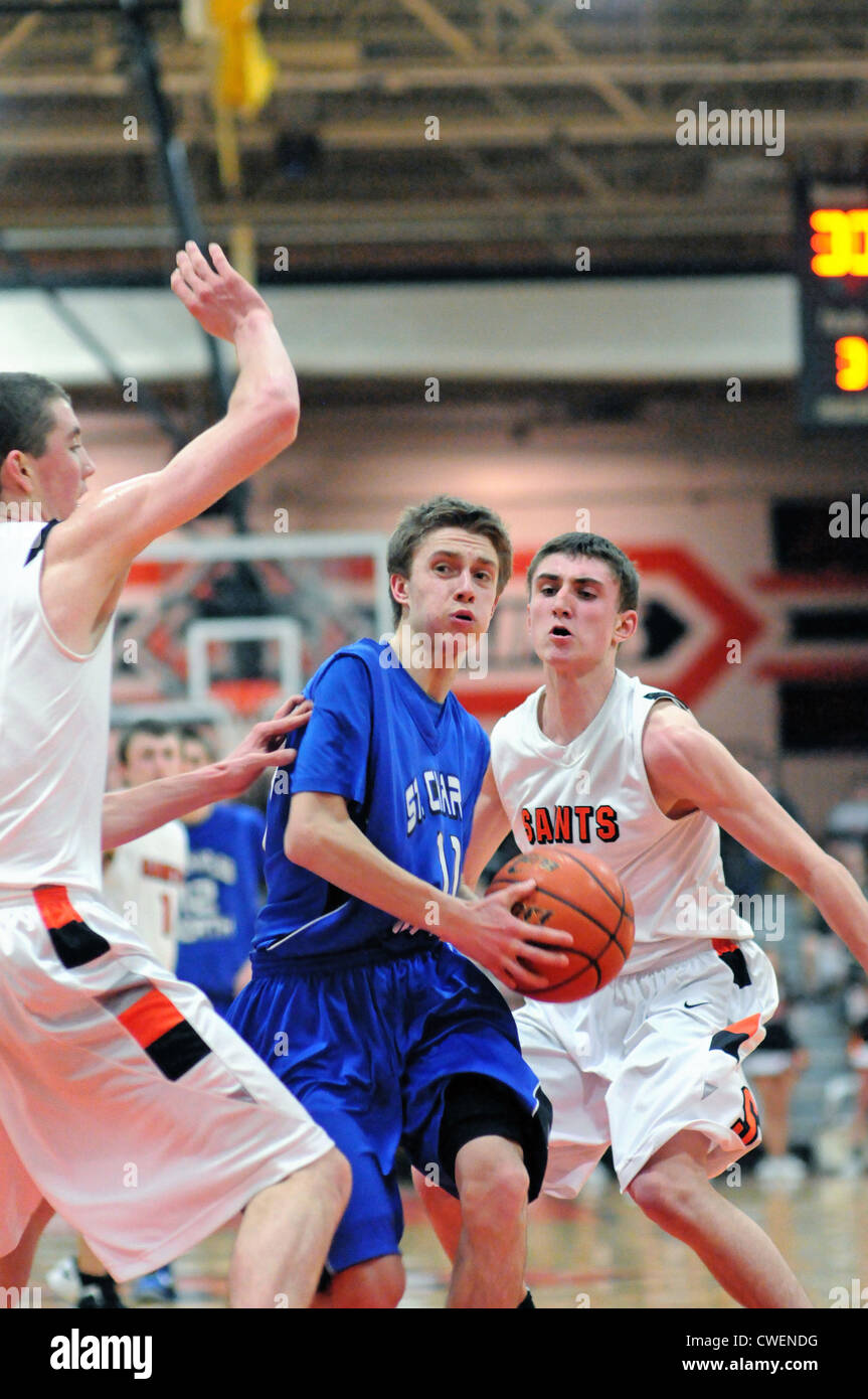 Basketball player attempts to split the defense while penetrating the paint in an effort to score. USA. Stock Photo