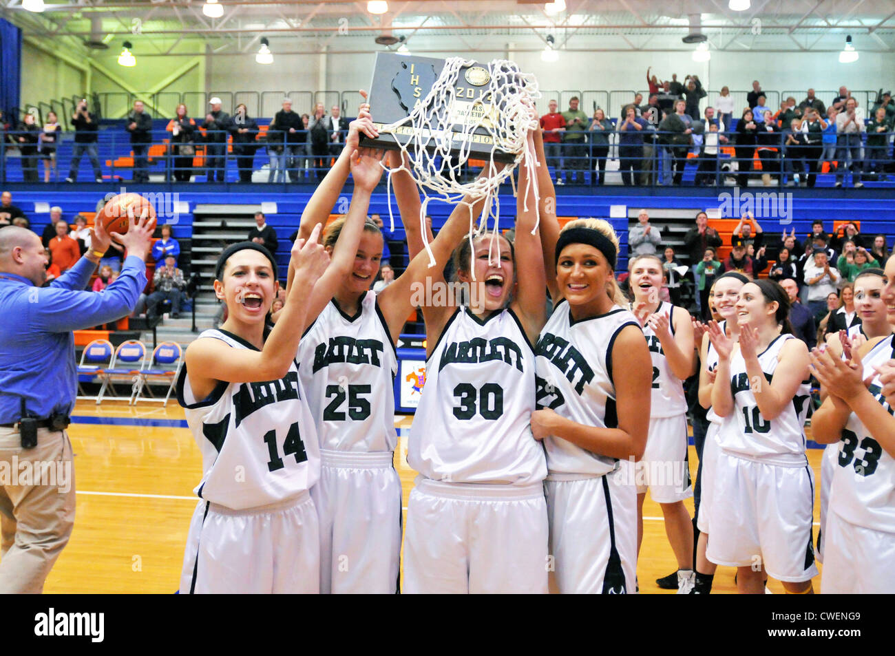 High school basketball team players celebrate an overtime sectional
