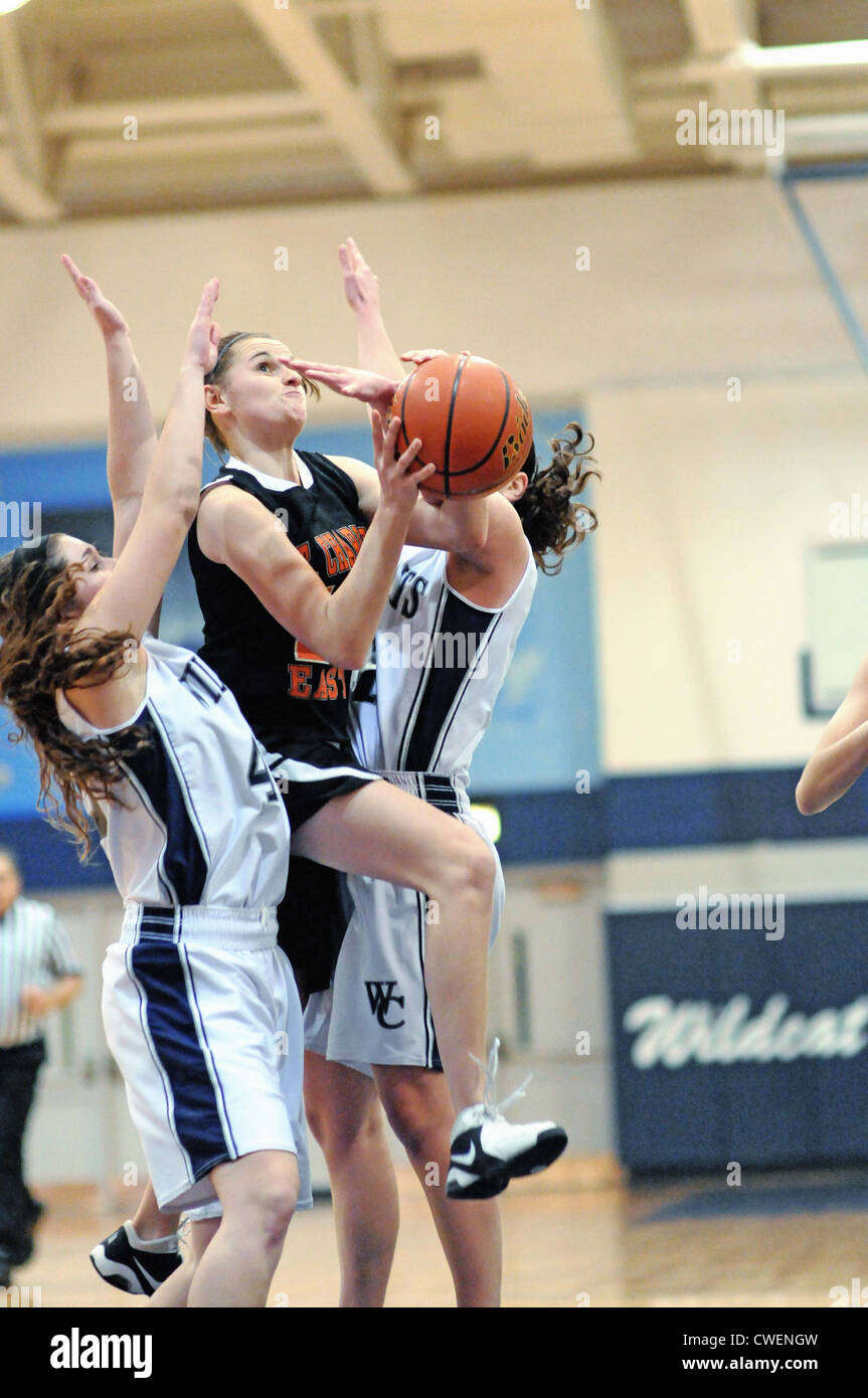 Basketball player splits defense to shoot Girls High school Game. USA. Stock Photo