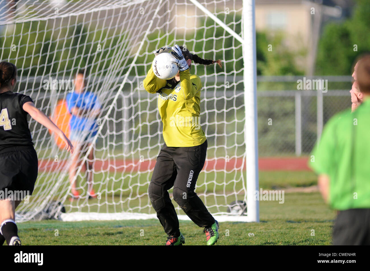 Soccer Goal keeper makes a save during a high school match. Stock Photo