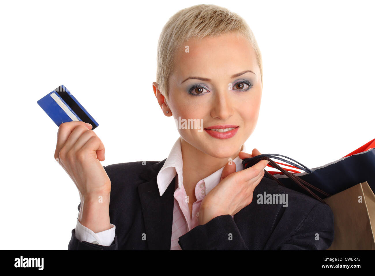 isolated on white of young woman with short hair and make-up professionally done, holding a shopping bags and credit card Stock Photo
