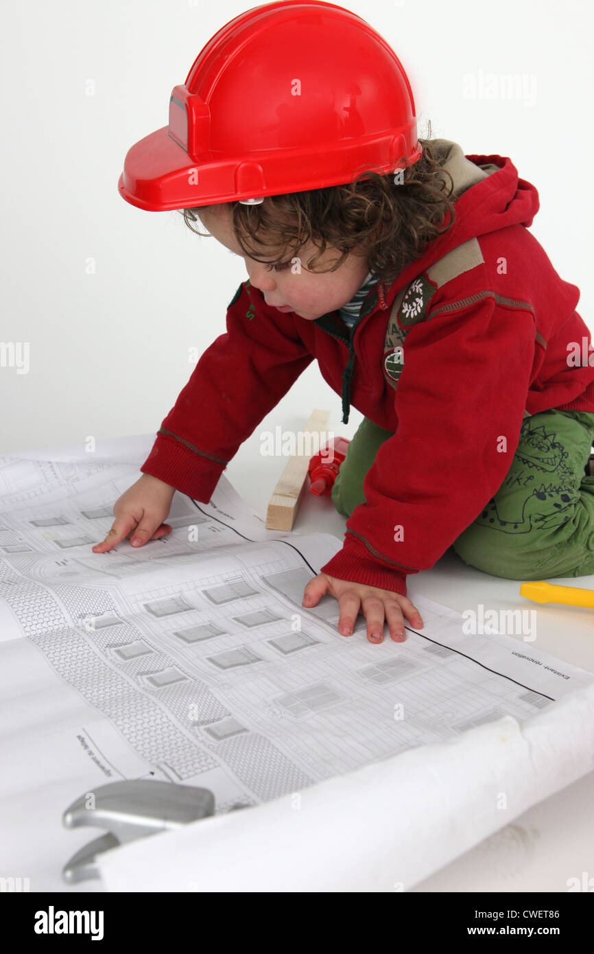 Little boy builder reading newspaper Stock Photo Alamy