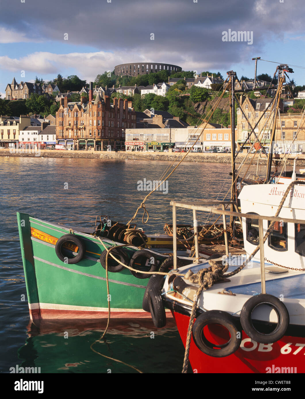Oban harbour, Argyll and Bute, Scotland, UK. McCaig's Tower is prominent on the skyline. Stock Photo
