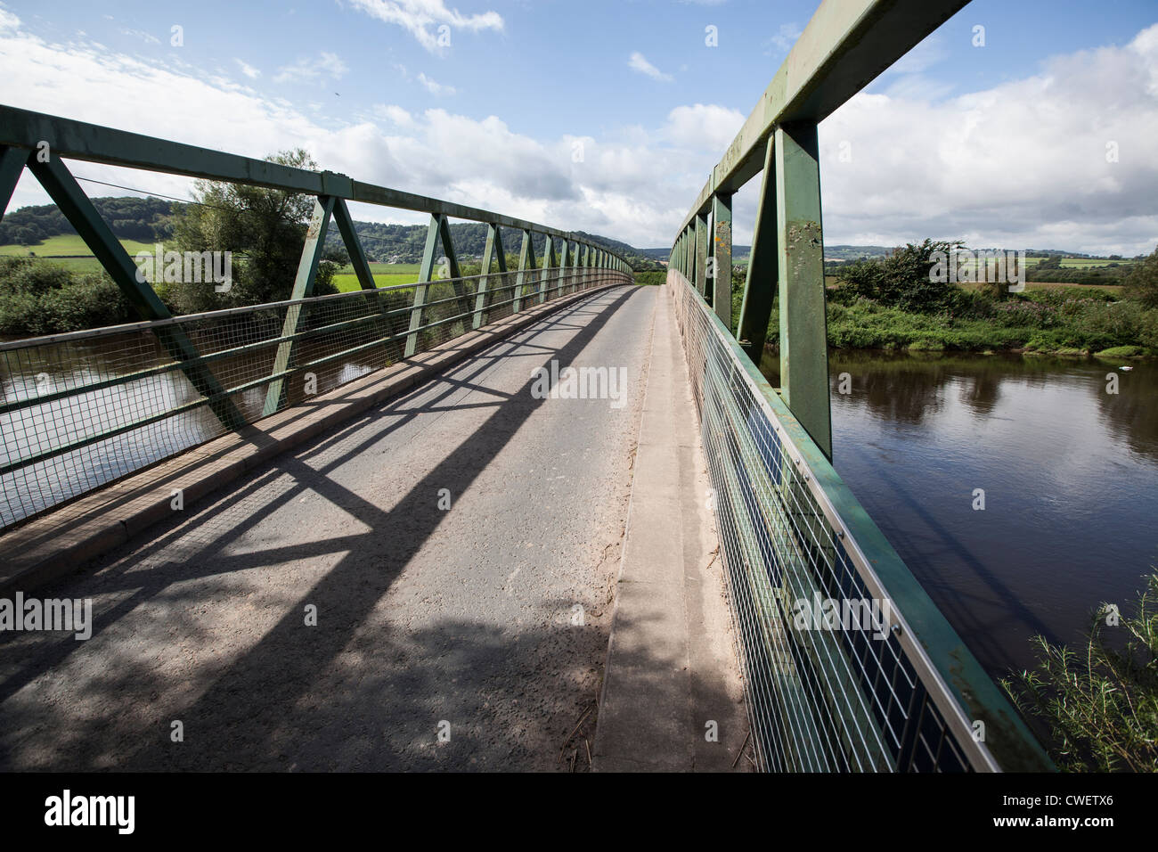 A metal road bridge crosses a stretch of the River Wye running in the