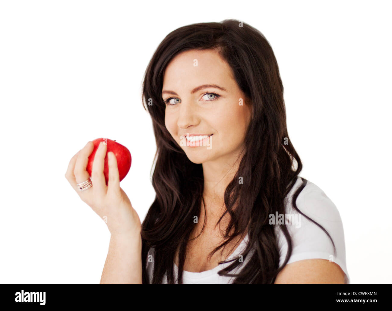 Beautiful young brunette lady about to eat a delicious red apple Stock Photo
