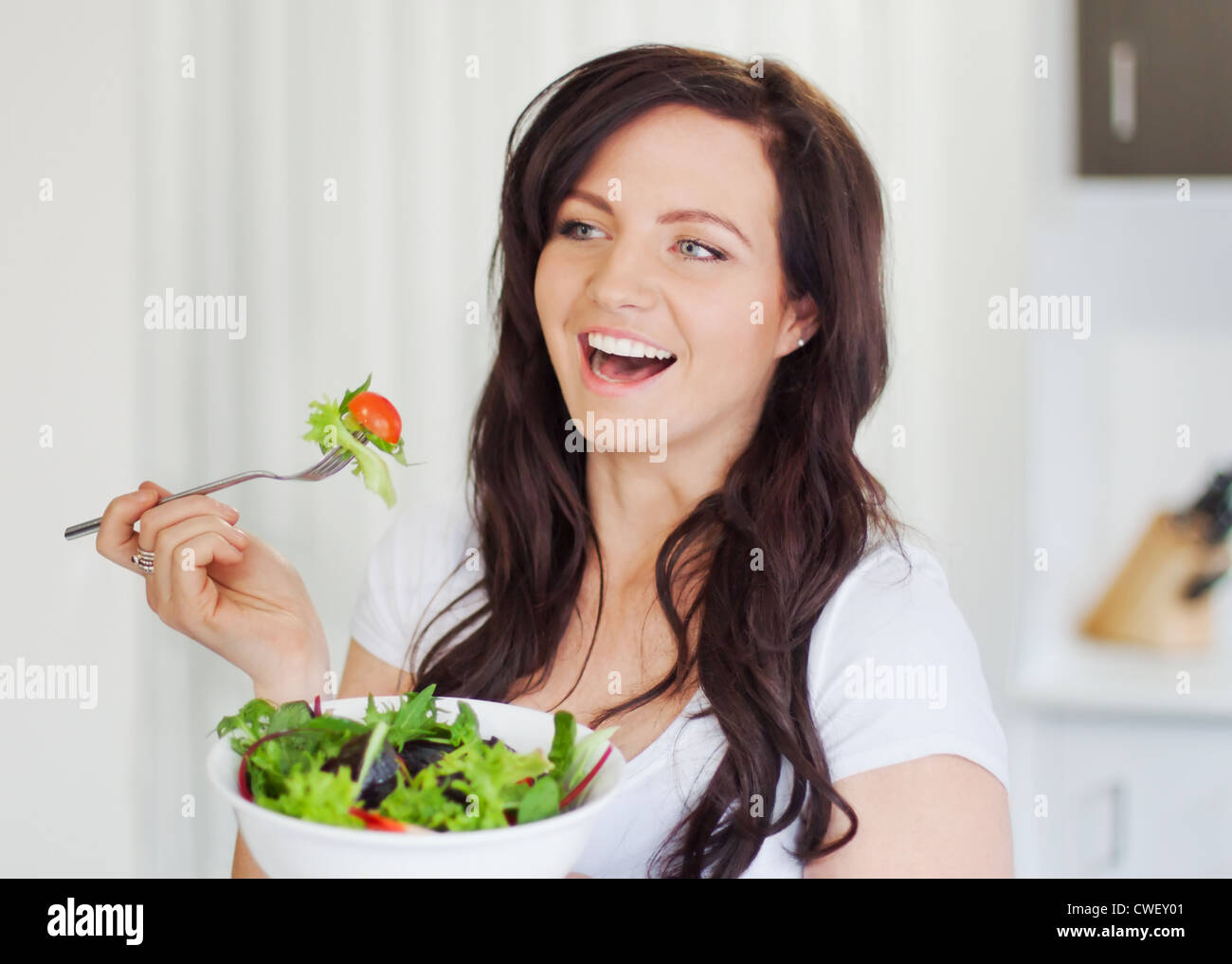 Attractive young woman eating a healthy salad Stock Photo