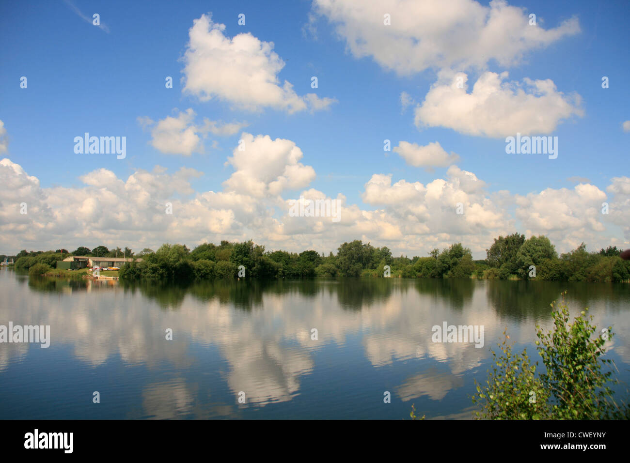 Cloud and tree reflections on a lake in North Hykeham, Lincoln in Lincolnshire, England Stock Photo