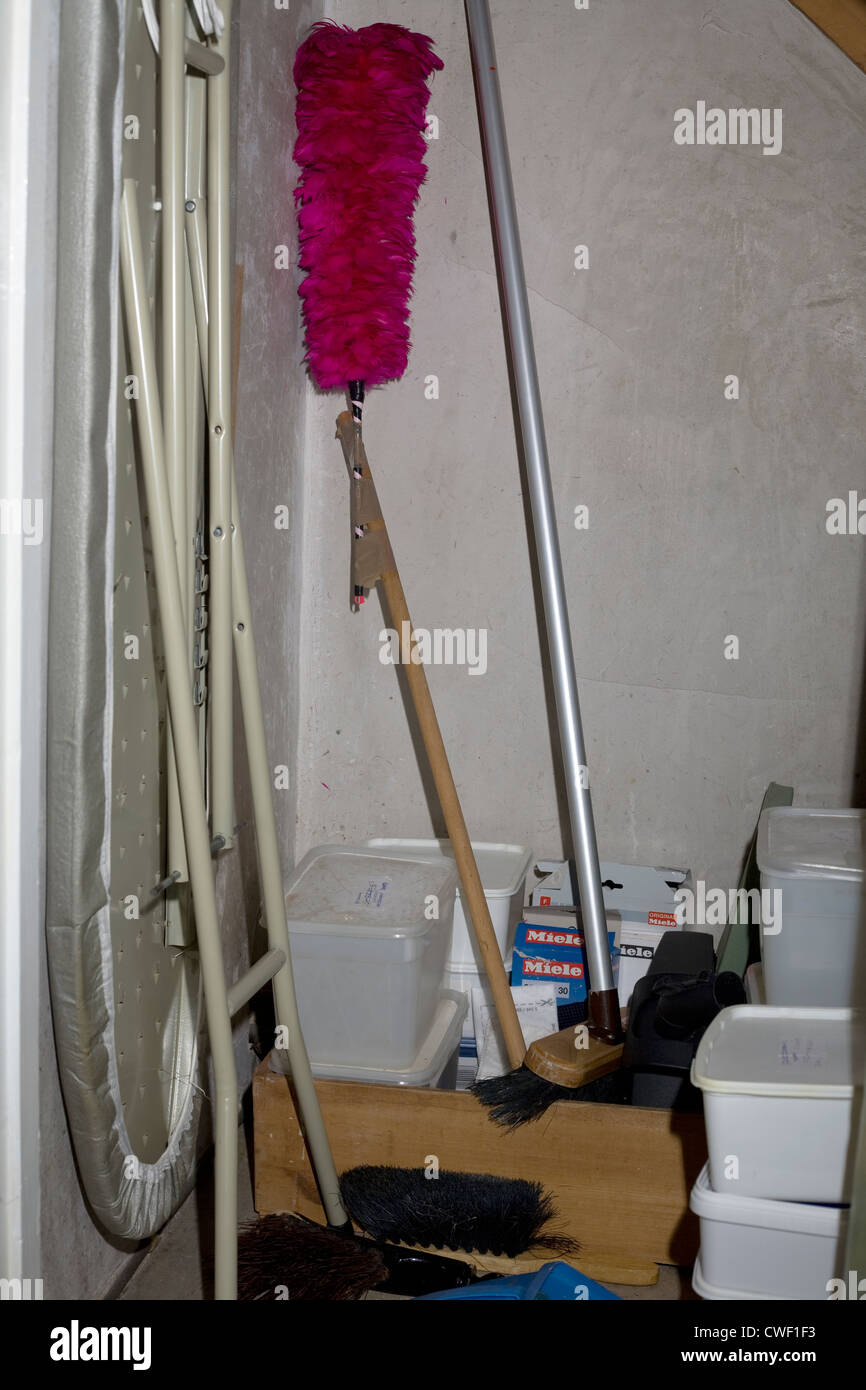 Understair cupboard with cleaning materials:brush,mop and ironing board Stock Photo