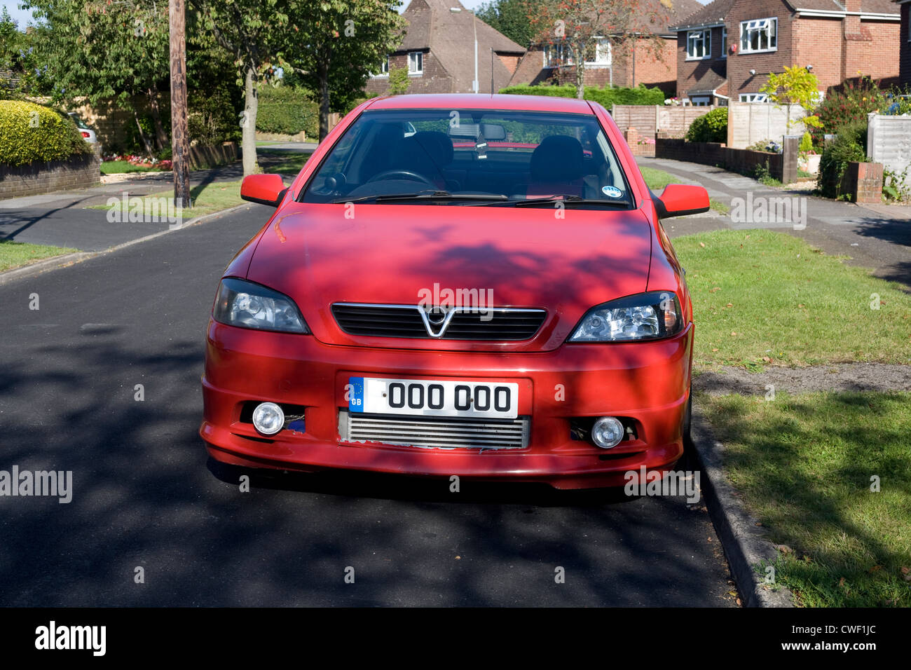 Red hatchback car parked in Norris Gardens, Warblington, a popular residential area in Havant, Hampshire Stock Photo