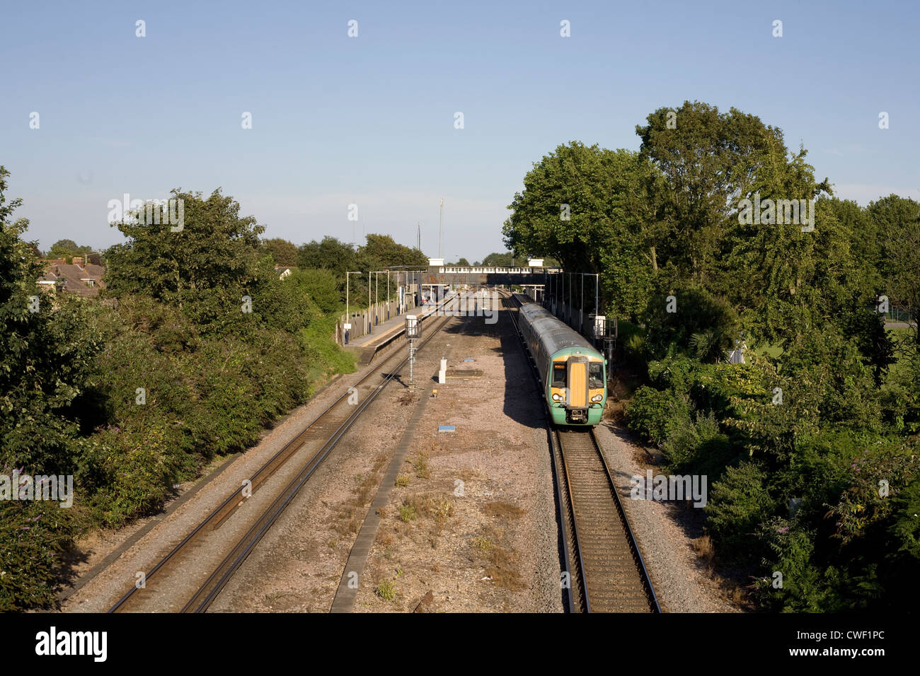 Havant railway station with electric train en route from Sussex to Portsmouth Stock Photo