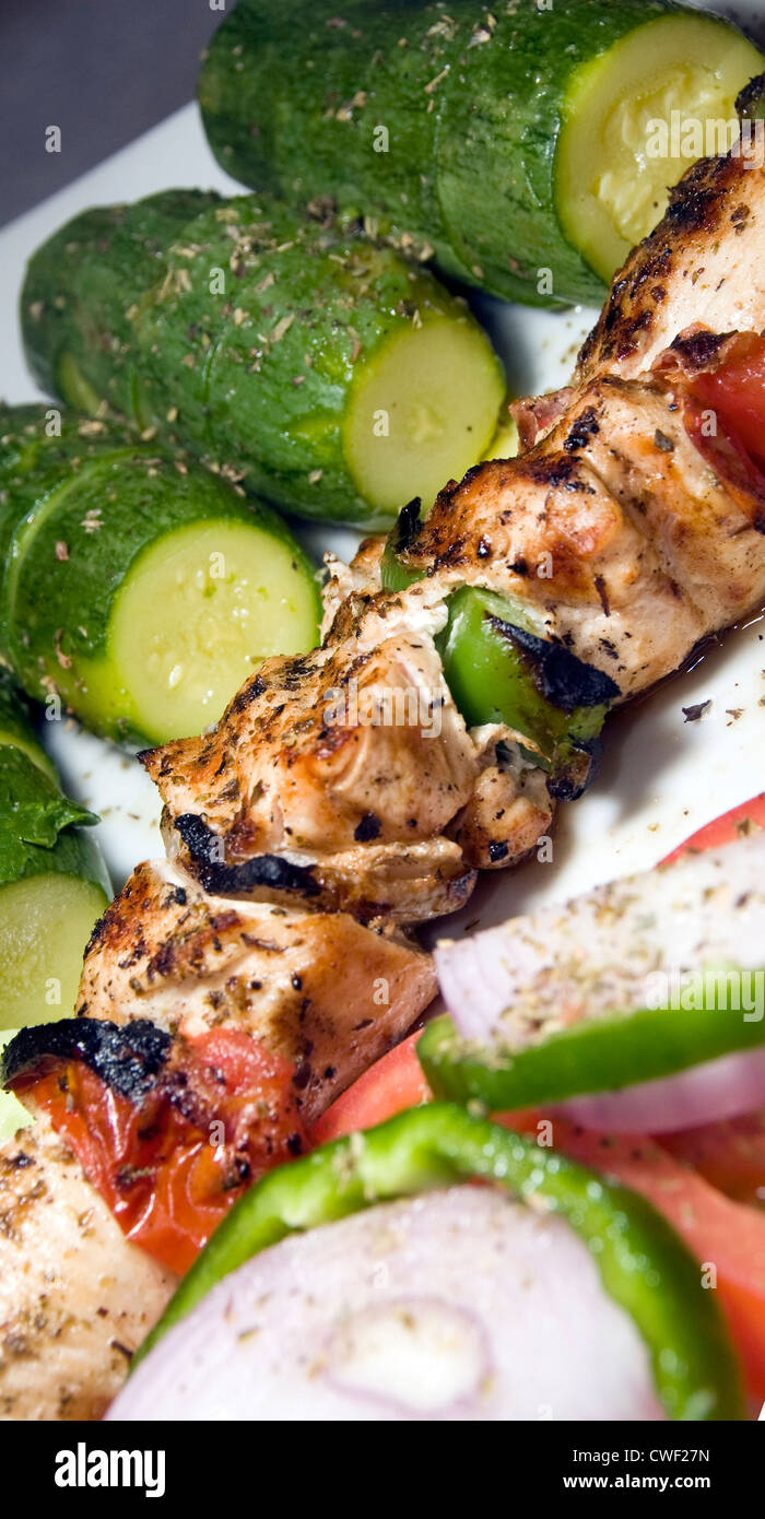 chicken shish kabob with zucchini and salad Greek style as photographed in Milos Greek Cyclades Island Stock Photo