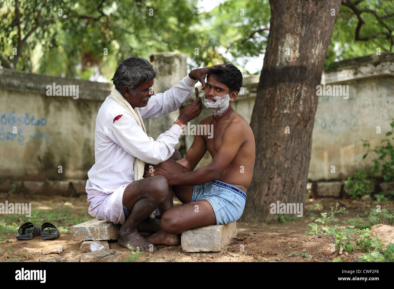 Rural Indian barber at work Andhra Pradesh South India Stock Photo