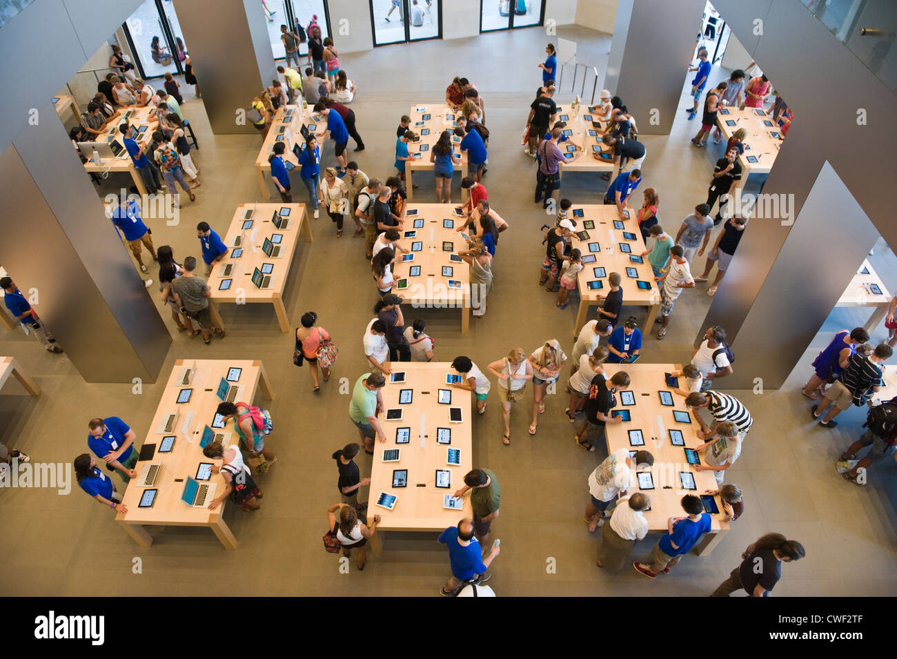 Interior of the Apple Store with customers browsing laptops, ipads and iphones in Barcelona, Catalonia, Spain, ES Stock Photo