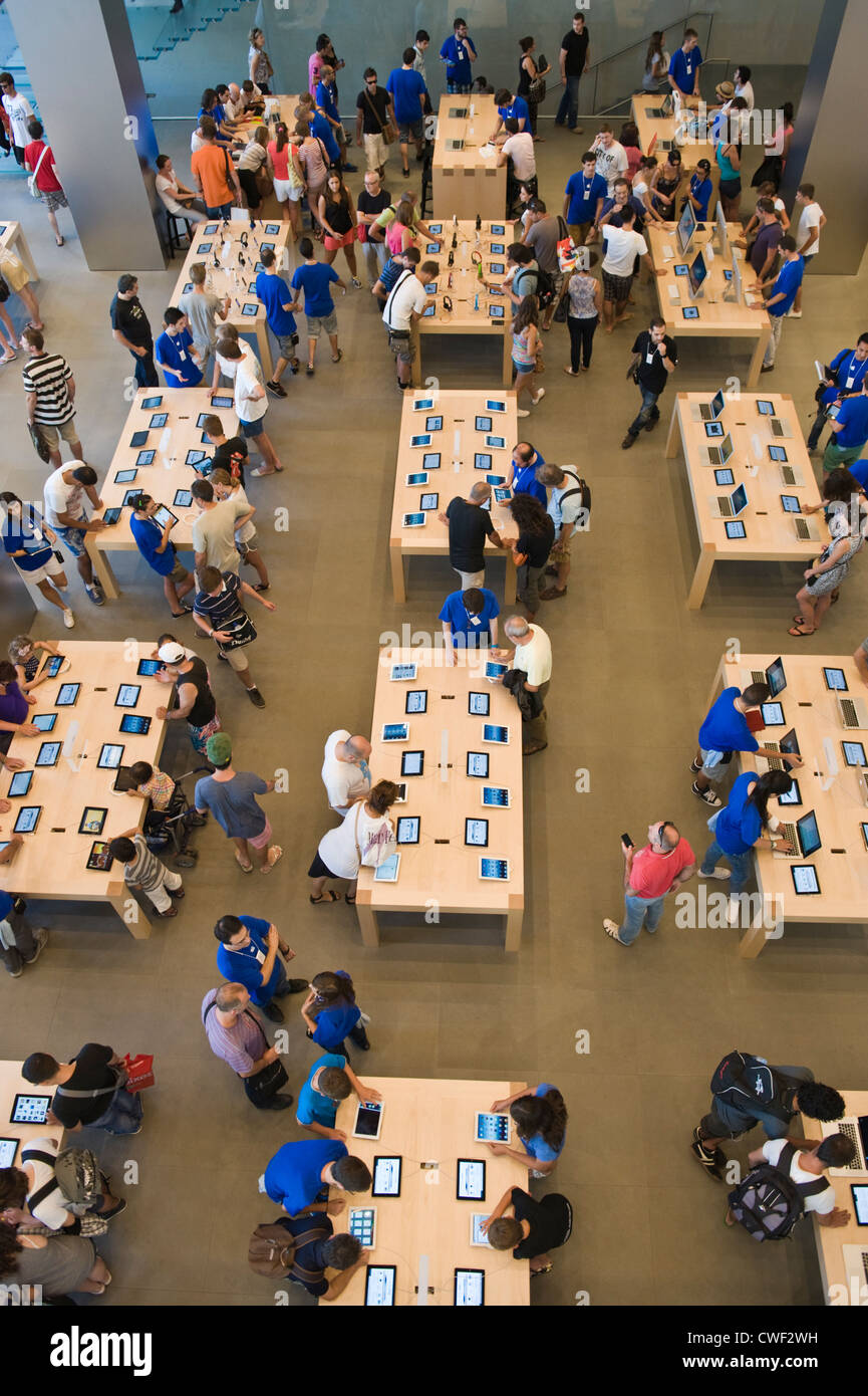 Interior of the Apple Store with customers browsing laptops, ipads and iphones in Barcelona, Catalonia, Spain, ES Stock Photo