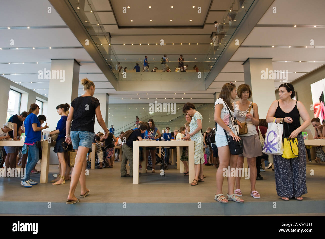 Interior of the Apple Store with customers browsing laptops, ipads and iphones in Barcelona, Catalonia, Spain, ES Stock Photo