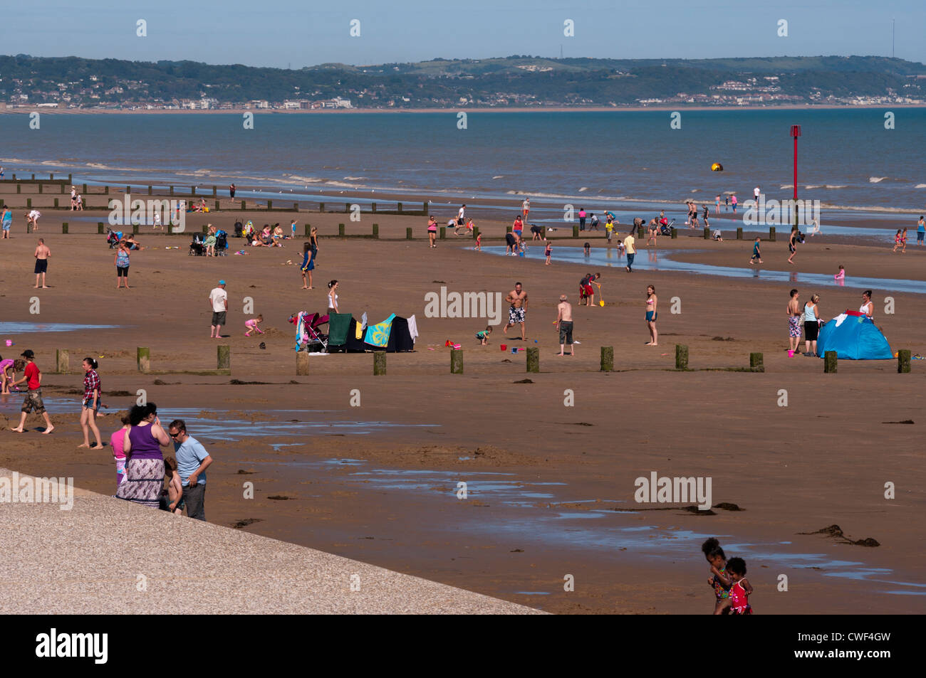 Holidaymakers On Dymchurch Beach Kent UK On A Summers Day Seaside Seasides Stock Photo