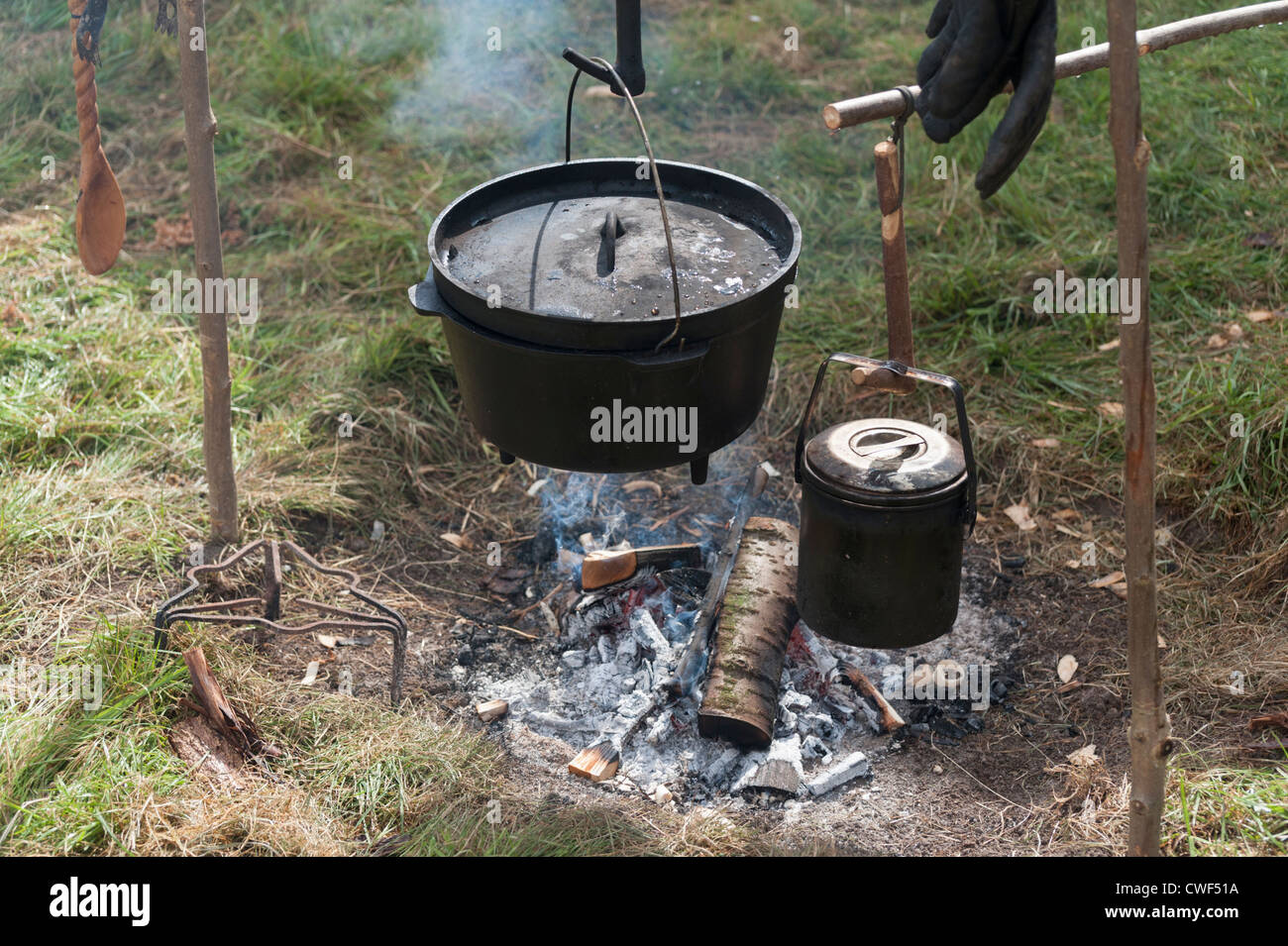 camping cooking on campfire with old iron pots Stock Photo - Alamy