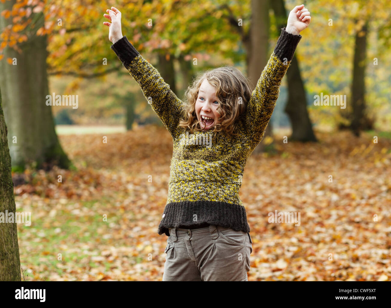 Happily excited teenager girl in an autumn park Stock Photo