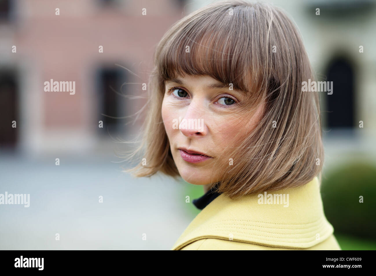 Horizontal outdoor portrait of a midlle aged woman turning back Stock Photo