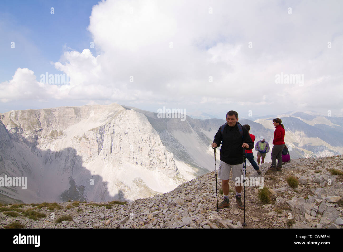 Hikers at the summit of Monte Vettore at an elevation of 2,478m (8,130ft) in the Apennines Italy Stock Photo