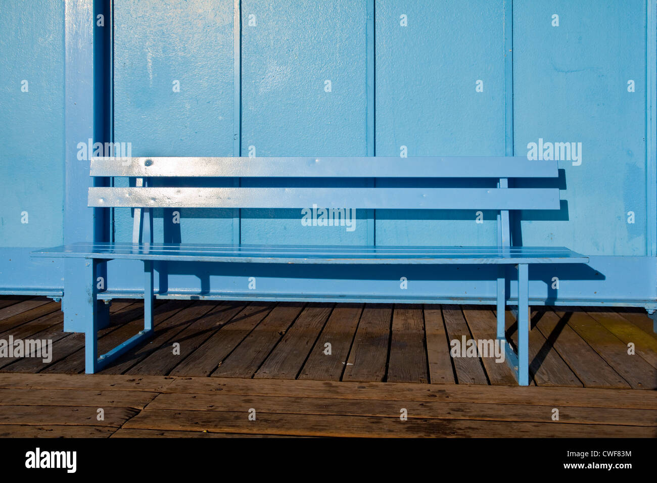 A blue bench seat on the pier at Herne Bay Kent UK Stock Photo