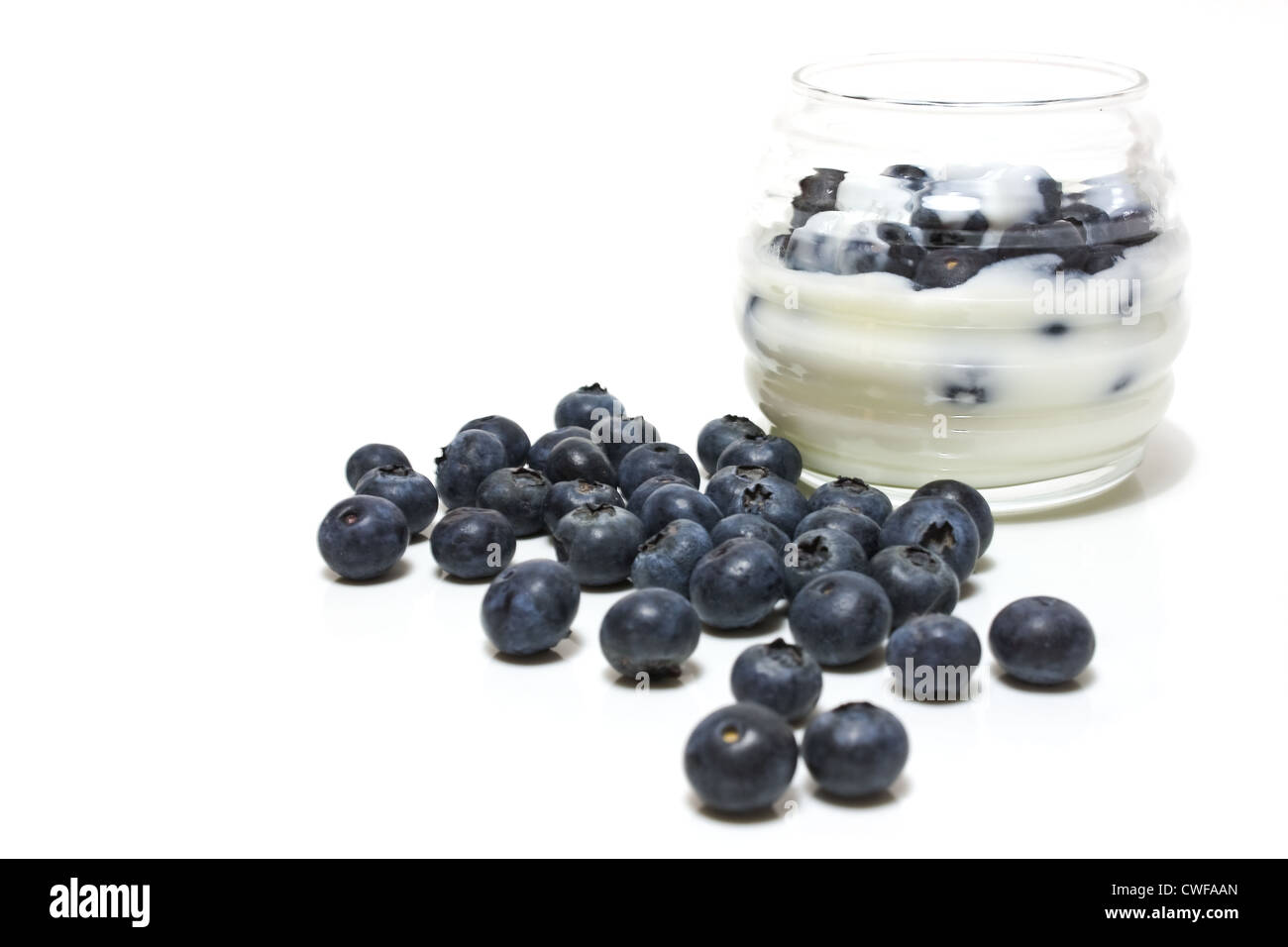 Bowl with yogurt and blueberries isolated on white background. Stock Photo