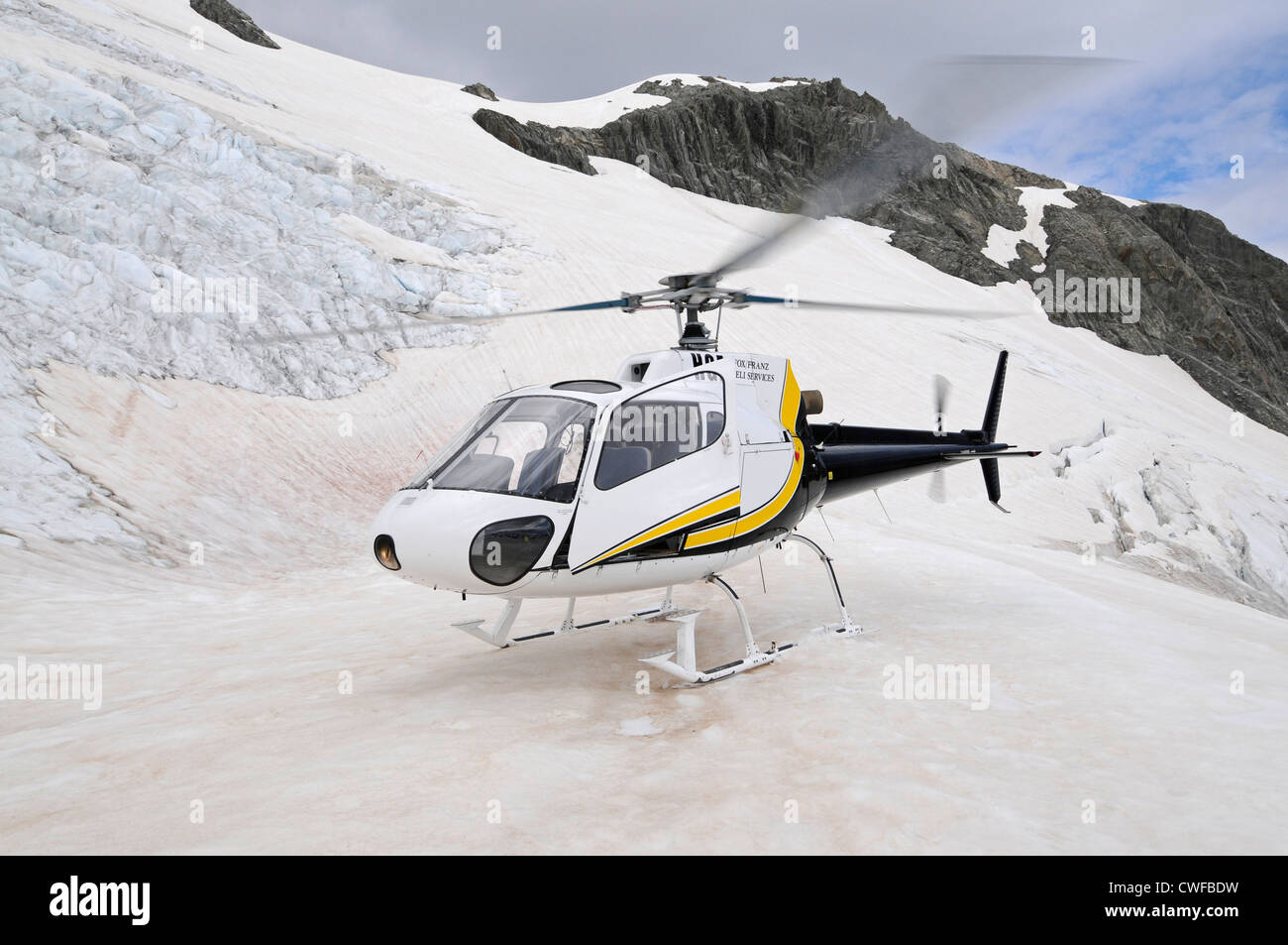 A six-seater sight-seeing helicopter on the top of the Franz Josef glacier in South Island, New Zealand.T Stock Photo