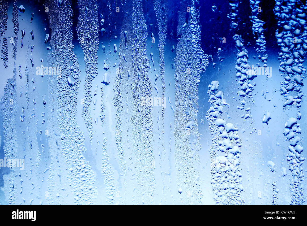 Drops of water on a blue color window glass Stock Photo - Alamy