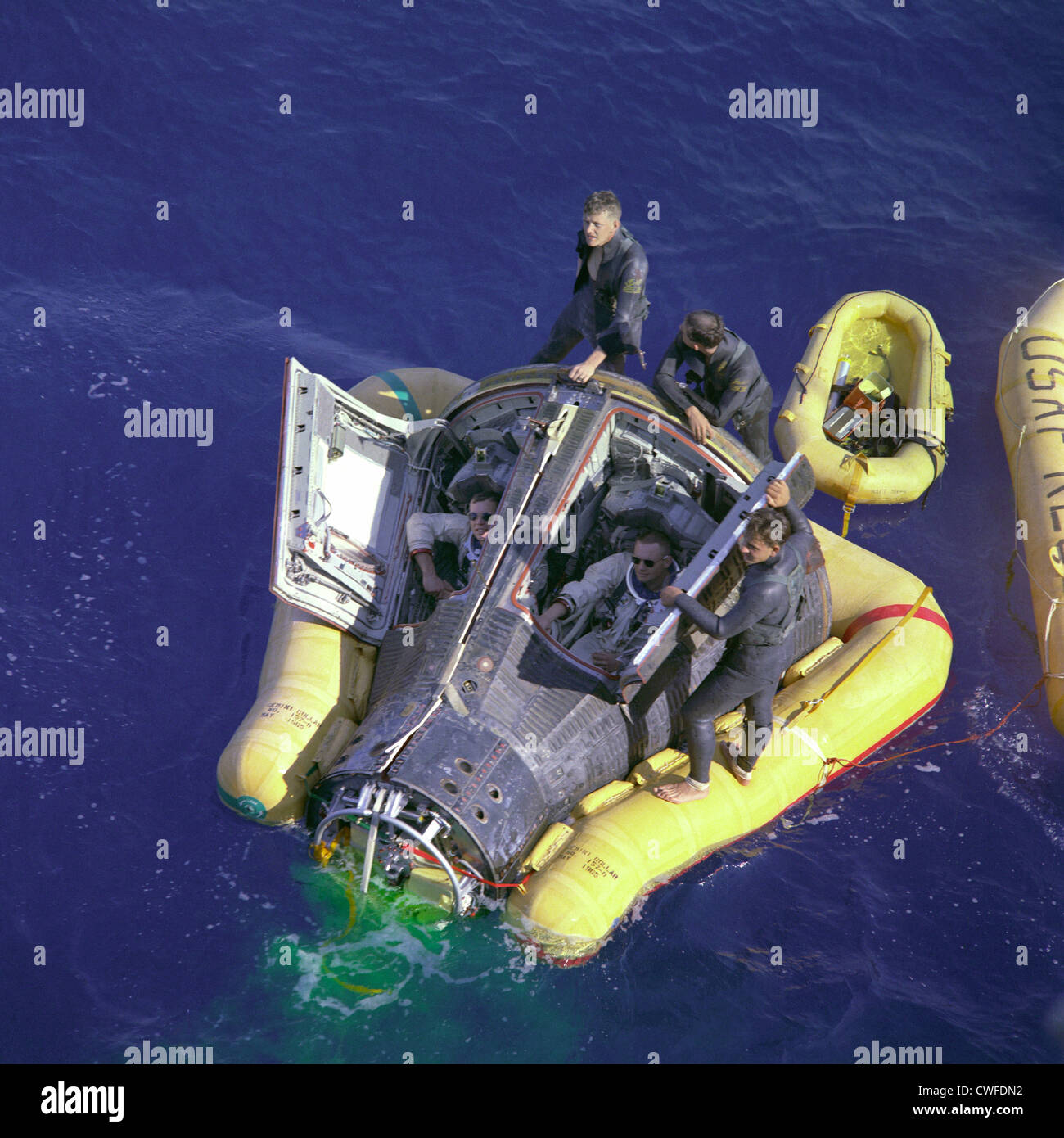 Astronauts Neil A. Armstrong and David R. Scott sit with their spacecraft hatches open while awaiting the arrival of the recovery ship, the USS Leonard F. Mason after the successful completion of their Gemini VIII mission March 16, 1966. The overhead view shows the Gemini 8 spacecraft with the yellow flotation collar attached to stabilize the spacecraft in choppy seas. The green marker dye is highly visible from the air and is used as a locating aid. Keywords Gemini 8 Gemini VIII Neil Armstrong David Scott Dave Scott Splashdown Recovery AF Pararescuemen Eldrige Neal Larry Huyett Glenn Moore Le Stock Photo