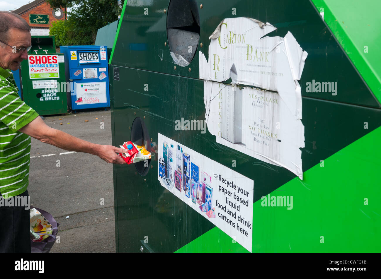 A man recycling a Tropicana carton at a recycling bank in Shifnal, Shropshire, England Stock Photo