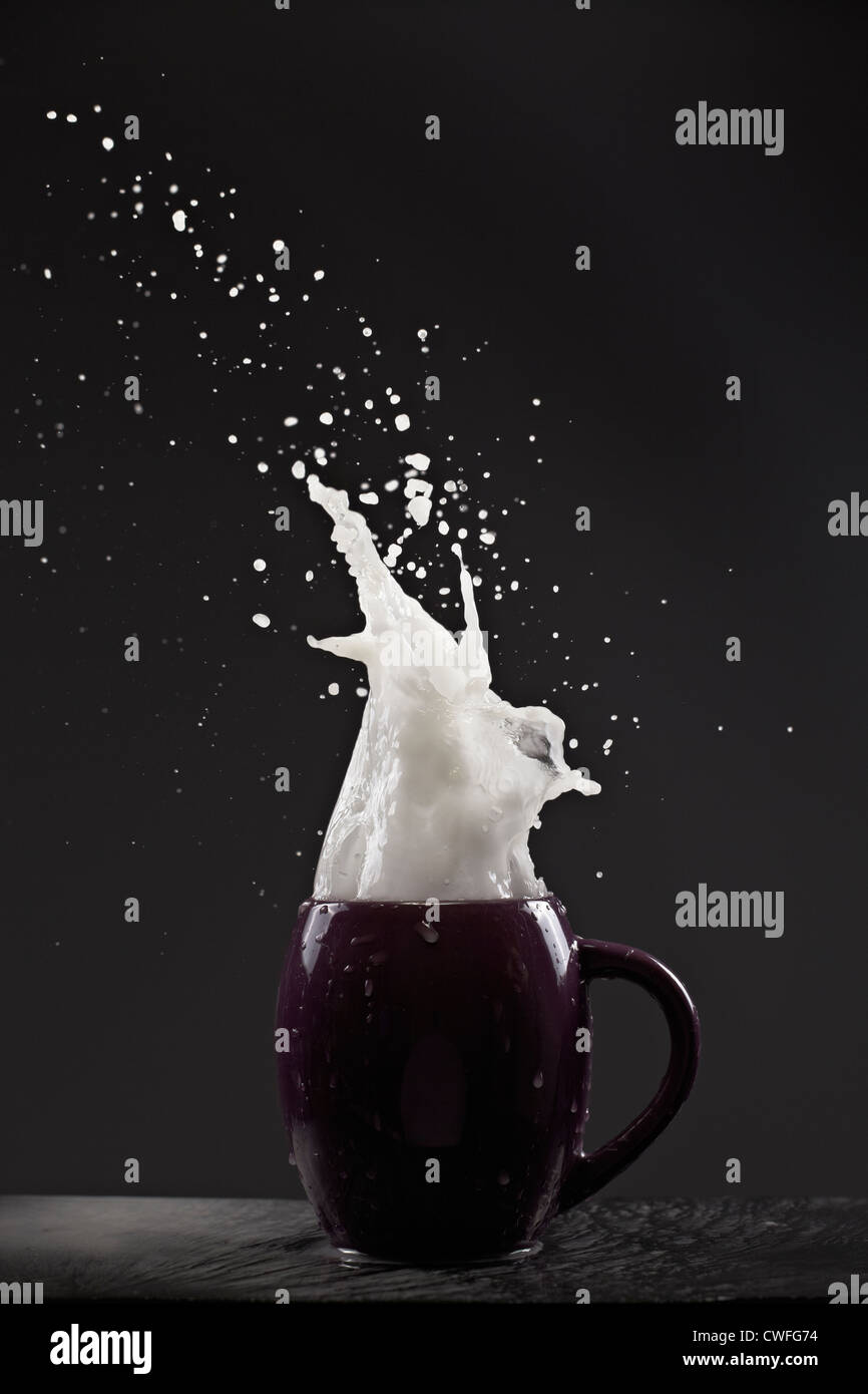 White liquid exploding out of a mug Stock Photo