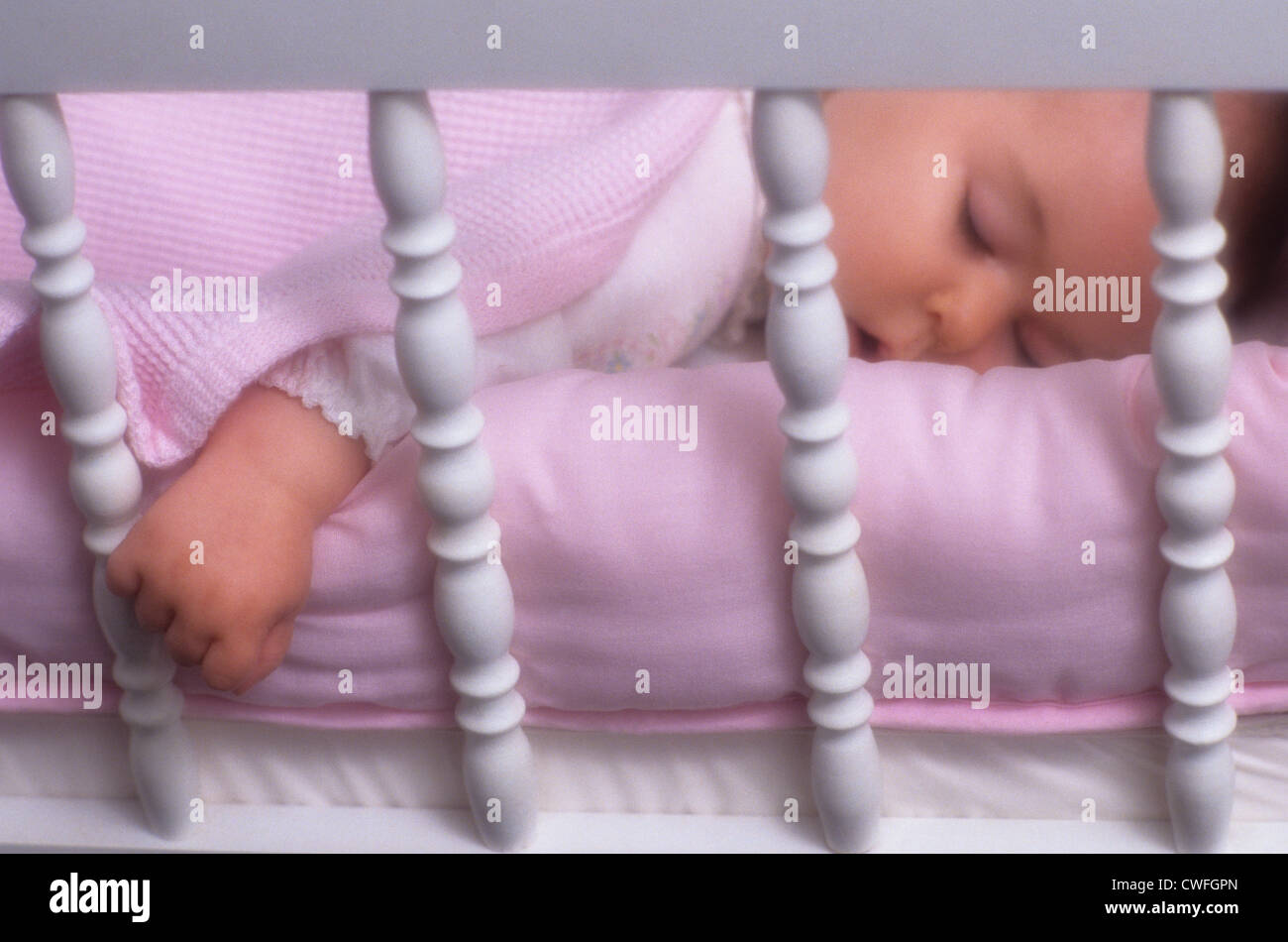 Baby girl in crib sleeping Stock Photo Alamy