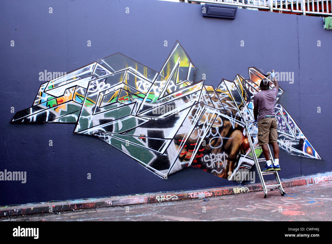 Graffiti artist creating a new fresco Stock Photo