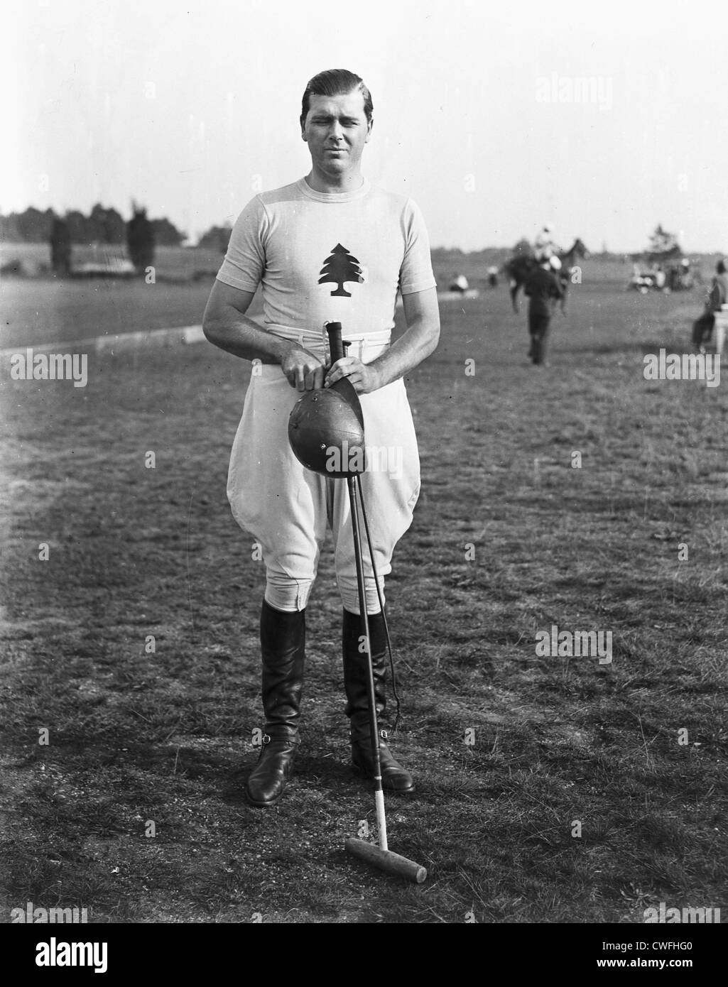 Gerald Balding of the Greentree Polo Team poses holding a polo mallet and helmet, ca 1934 Stock Photo