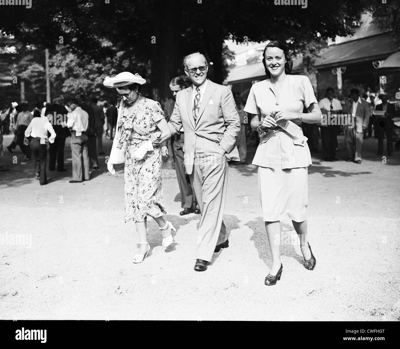 Rose and Joseph P. Kennedy walk with Mrs Milton C Klugh at the racetrack in Saratoga, New York, 1947 Stock Photo