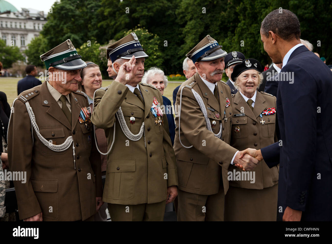 President Barack Obama greets veterans following a wreath laying ceremony at the Tomb of the Unknown Soldier in Warsaw, Poland, Stock Photo